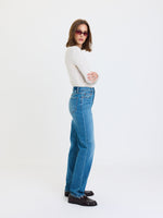 Daze Denim Sundaze High Rise Vintage jeans in Cloudline medium blue wash, side view on model with white top and loafers
