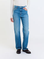 Daze Denim Sundaze High Rise Vintage jeans in medium blue wash, straight leg fit, front view on model with white ribbed top and loafers.