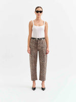 Daze Denim Westward Barrel Leg jeans in Cool Cool Cat leopard print, worn by model with white corset top and black belt