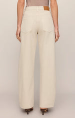 Z SUPPLY Show Off High Rise Bowed jeans in Soapstone, back view on model showing wide-leg silhouette and tan leather logo patch