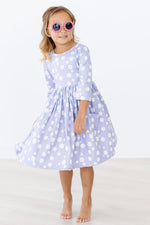 Mila Dainty Daisies 3/4 Sleeve Pocket Twirl Dress in lavender with white daisy print, worn by young girl with pink sunglasses