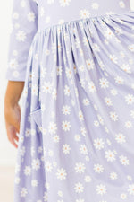 Mila Dainty Daisies 3/4 Sleeve Pocket Twirl Dress close-up showing lavender fabric with white daisy print and side pocket