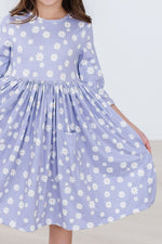 Mila Dainty Daisies 3/4 Sleeve Pocket Twirl Dress in lavender with white daisy print, front close-up on child model