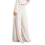 Free People Dream State Pants in heather grey, wide-leg silhouette with smocked waist, worn with a white crop top, side view
