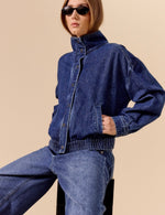 Daze Denim Phantom Funnel Neck Jacket in Rush medium blue denim, worn by model with wide-leg jeans, front view