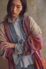 Free People Enid Cardi in Ocean Sunset Combo, multicolor space-dye knit cardigan with wide sleeves, layered over denim, front view.
