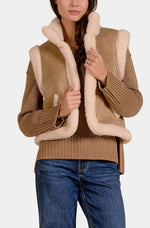 Elan 9 Vest Slvless in mocha tan suede with cream sherpa lining, worn over ribbed knit sweater, front view on model