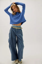 Free People Opal Sweater in Peri Blue — cropped knit turtleneck with wide sleeves, worn with wide-leg cargo pants, front view.