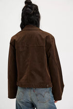 Free People Blair Vegan Suede Jacket in Chocolate Torte, back view on model, paired with Levi's jeans.
