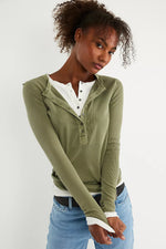 Free People Jamie Henley in Capulet Olive, long-sleeve ribbed top with snap buttons, layered over white henley, front view.