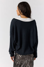 Free People See Me V-Neck Pullover in black, back view on model, oversized fit with wide neckline and raglan sleeves