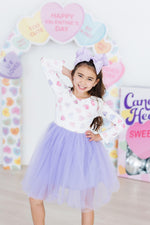 Mila Never Miss A Beat L/S Tutu Dress in white with colorful hearts and lavender tulle skirt, worn by young girl with purple bow