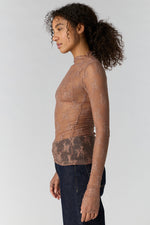 Free People Lady Lux Layering Top in Chocolate Malt — sheer floral lace mock-neck long-sleeve top, side view on model