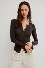 Free People Going Places Cardi in Deep Fudge dark brown, waffle-knit long sleeve top with snap buttons, worn by model with cream jeans