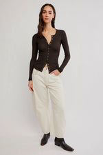 Free People Going Places Cardi in Deep Fudge dark brown, snap-front ribbed long-sleeve top worn by model with cream wide-leg pants