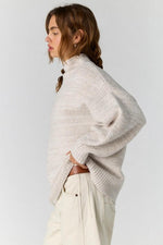 Free People Beaumont Tunic in Feather Grey Melange, side view on model showing oversized turtleneck knit sweater with drop shoulders