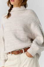 Free People Beaumont Tunic in Feather Grey Melange, oversized mock-neck knit sweater with drop shoulders, worn with cream jeans