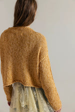 Back view of Opal Sweater in Sweet Potato by Tempemail.Pdf — chunky knit cropped mustard-gold sweater worn over a lace skirt
