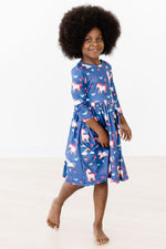 Mila Painted Skies 3/4 Sleeve Pocket Twirl Dress in blue with unicorn print, worn by young girl twirling, front view