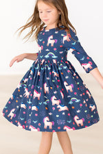 Mila Painted Skies 3/4 Sleeve Pocket Twirl Dress in navy with unicorn and rainbow print, worn by a young girl mid-twirl