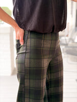 Sanctuary Relay Pull On Pant in Kalamata Plaid — close-up side view of green, brown, and black plaid wide-leg trousers with side pocket detail.