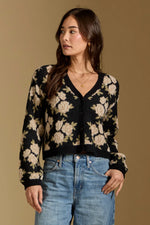 Saltwater Luxe Calian Sweater in black floral jacquard knit, V-neck cardigan with cream roses, worn by model with blue jeans
