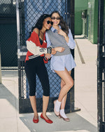 Steve Madden Rooney Jacket in Lava Flow red worn by model with varsity-style colorblock design, cream sleeves, and stripe trim