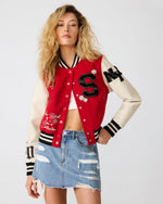 Steve Madden Rooney Jacket in red and cream varsity style with 'S' patch, worn by model with distressed denim mini skirt