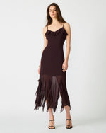 Steve Madden Mariane dress in chocolate brown with ruffle neckline and asymmetrical chiffon hem on model