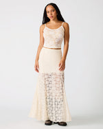 Model wearing STEVE MADDEN Mirabel cream lace two-piece set with cropped cami top and floor-length sheer skirt