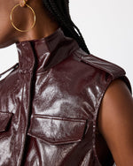 Steve Madden SC01142 sleeveless patent leather vest in Deep Fig burgundy with cargo pockets and mock neck, worn by model