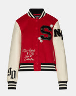 Steve Madden Rooney Jacket in red and cream varsity style with black letter patches, snap buttons, and 'New York City Icon Collection' script, flat lay front view.