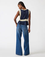 Steve Madden SC09035 top in Midnight navy blue with cream lace trim, back view on model wearing wide-leg jeans