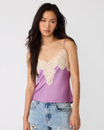 Steve Madden Miriah Top in dusty lavender satin with cream lace V-neckline trim and spaghetti straps, worn by model with jeans
