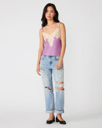 Steve Madden Miriah Top in dusty lavender satin with cream lace trim, styled with distressed boyfriend jeans on a model, front view
