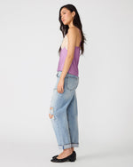 Steve Madden Miriah Top in dusty lavender with cream lace trim neckline, worn by model with distressed jeans, side view