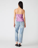 Steve Madden Miriah Top in dusty lavender satin with thin straps, back view on model wearing light wash cuffed jeans