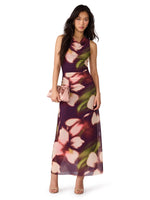 Steve Madden Rylen Dress in Blurry Floral print — sleeveless maxi mesh dress with draped neckline, model holding pink clutch