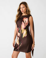 Steve Madden Mani Dress in dark brown with abstract tulip floral print, draped neckline, and trailing side scarf detail, worn by model