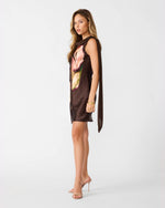 Steve Madden Mani Dress in dark brown satin with large floral print, side view on model with draped back detail and nude heels