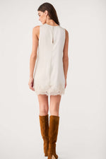 Z Supply Meadow Muse Lace Mini Dress in Frosted Pearl, back view on model with brown knee-high suede boots, lace hem detail