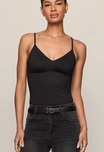 Z SUPPLY Luxe Smooth Essential Tank in black, V-neck spaghetti strap bodysuit worn by model with dark jeans and belt, front view.