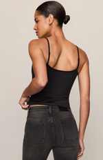 Z SUPPLY Luxe Smooth Essential Tank in black, back view on model, showing thin adjustable straps and fitted silhouette with dark wash jeans.