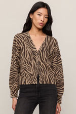 Z SUPPLY All The Wild Cardigan in dark chocolate zebra print, V-neck button-front style, worn by model with black jeans, front view.