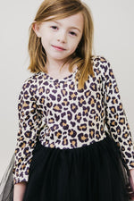 Mila Wild One L/S Tutu Dress on young girl — leopard print long-sleeve bodice with black tulle skirt, front view