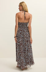 Z SUPPLY Lanie Zinn Floral Maxi Dress in Chocolate Cherry - back view of model wearing halter-style dress with tropical leaf print in brown and blue tones