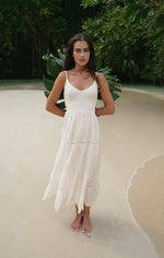 Z SUPPLY Behati Eyelet Midi Dress in white worn by model on tropical beach, featuring tiered skirt and eyelet details