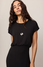 Z SUPPLY Anika Midi Dress in Black on model, short cap sleeves, round neckline, elasticated waist, paired with silver pendant necklace.
