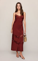 Z SUPPLY Bruna Lace Inset Midi Dress in Velvet Rouge, a deep burgundy satin slip dress with lace trim detailing, worn by a model with strappy heels and a woven bag.
