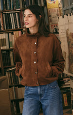 Z SUPPLY Corin Bubble Hem Jacket in Saddle Suede brown, snap-button front, mock neck, worn by model with blue jeans